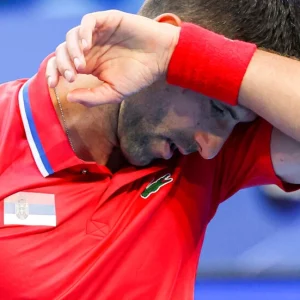 Djokovic wrist injury dooms Serbia as Poland power past China