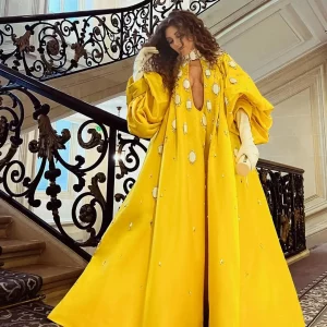 Myriam Fares in revealing yellow dress at Paris Fashion Week