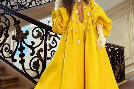 Myriam Fares in revealing yellow dress at Paris Fashion Week