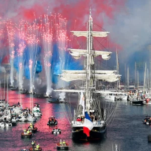 Olympic flame sails into Marseille port, marking milestone on path to Paris Games