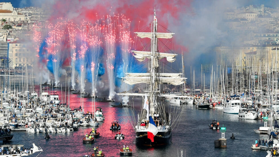Olympic flame sails into Marseille port, marking milestone on path to
